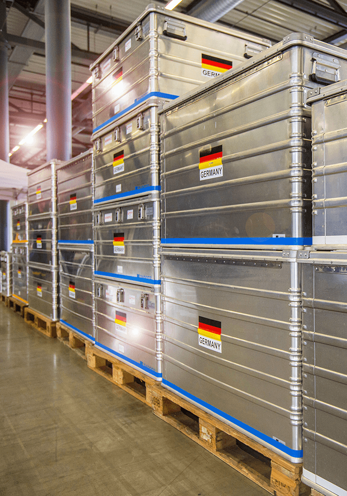 Row of metal boxes with German flag in a hall of FOUR PACK