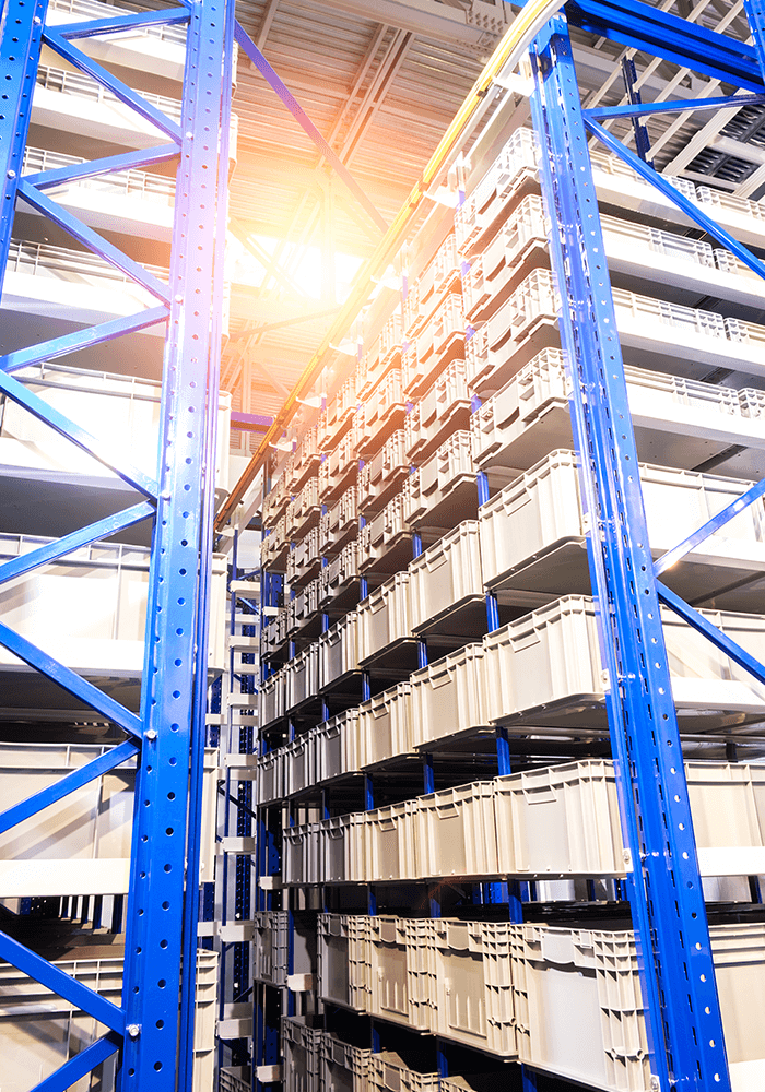 High metal shelf with blue beams and numerous storage boxes at FOUR PACK